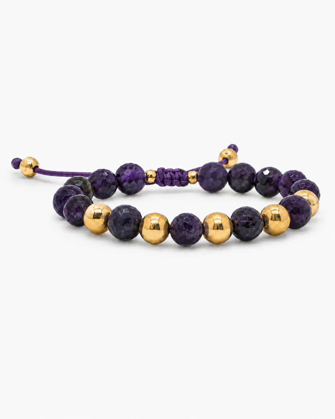 Bracelet with purple and gold beads on a white background