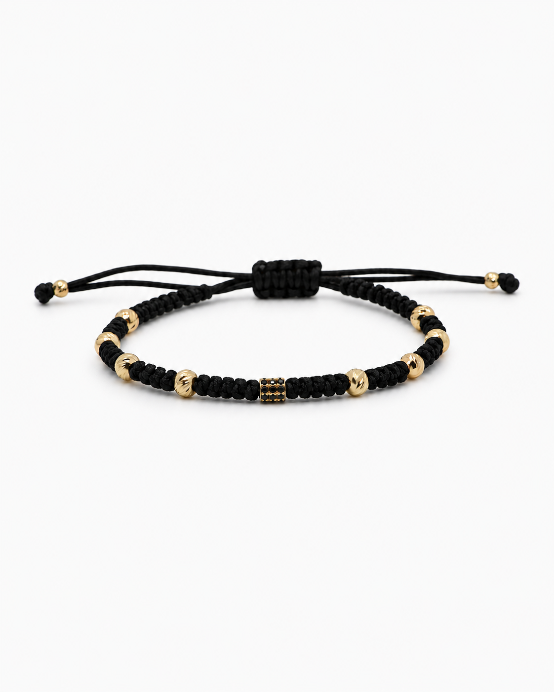 Black macrame bracelet with gold and black beads on a white background
