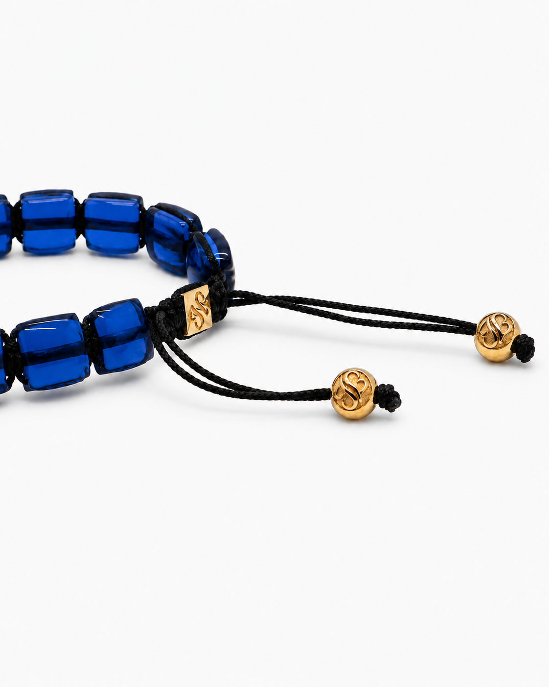 Blue beaded bracelet with gold accents on a white background