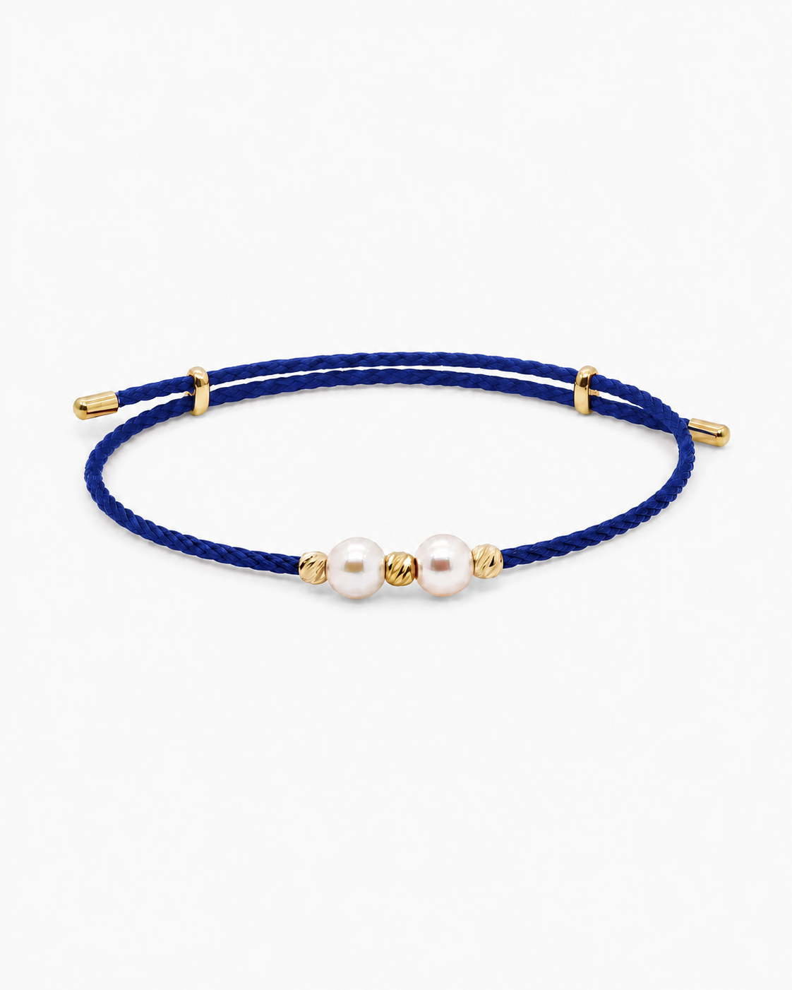 Navy blue bracelet with gold accents and pearls on a white background #Color_