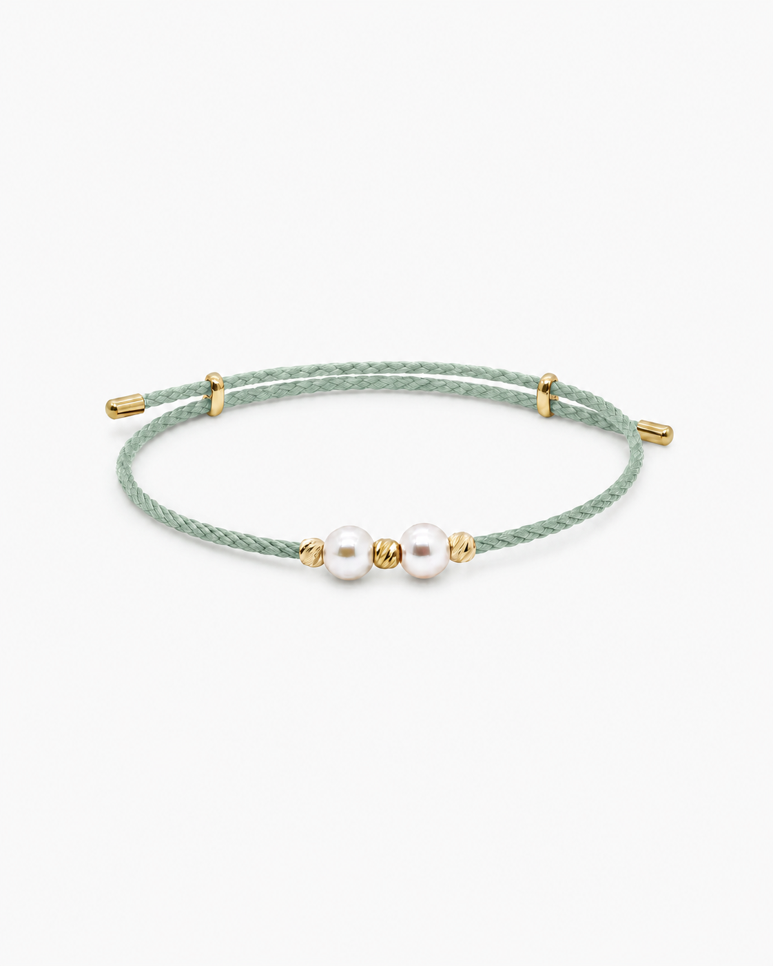 Green bracelet with pearls and gold accents on a white background #Color_