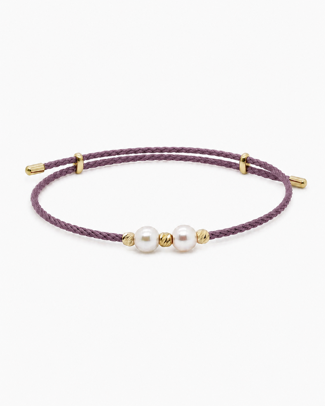 Purple bracelet with gold accents and pearls on a white background #Color_