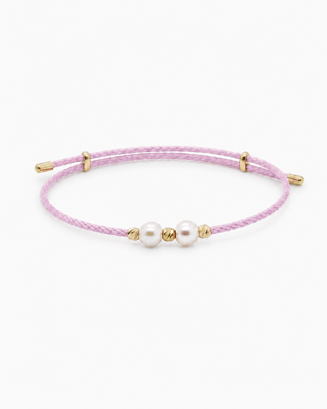 Pink bracelet with pearls and gold accents on a white background #Color_