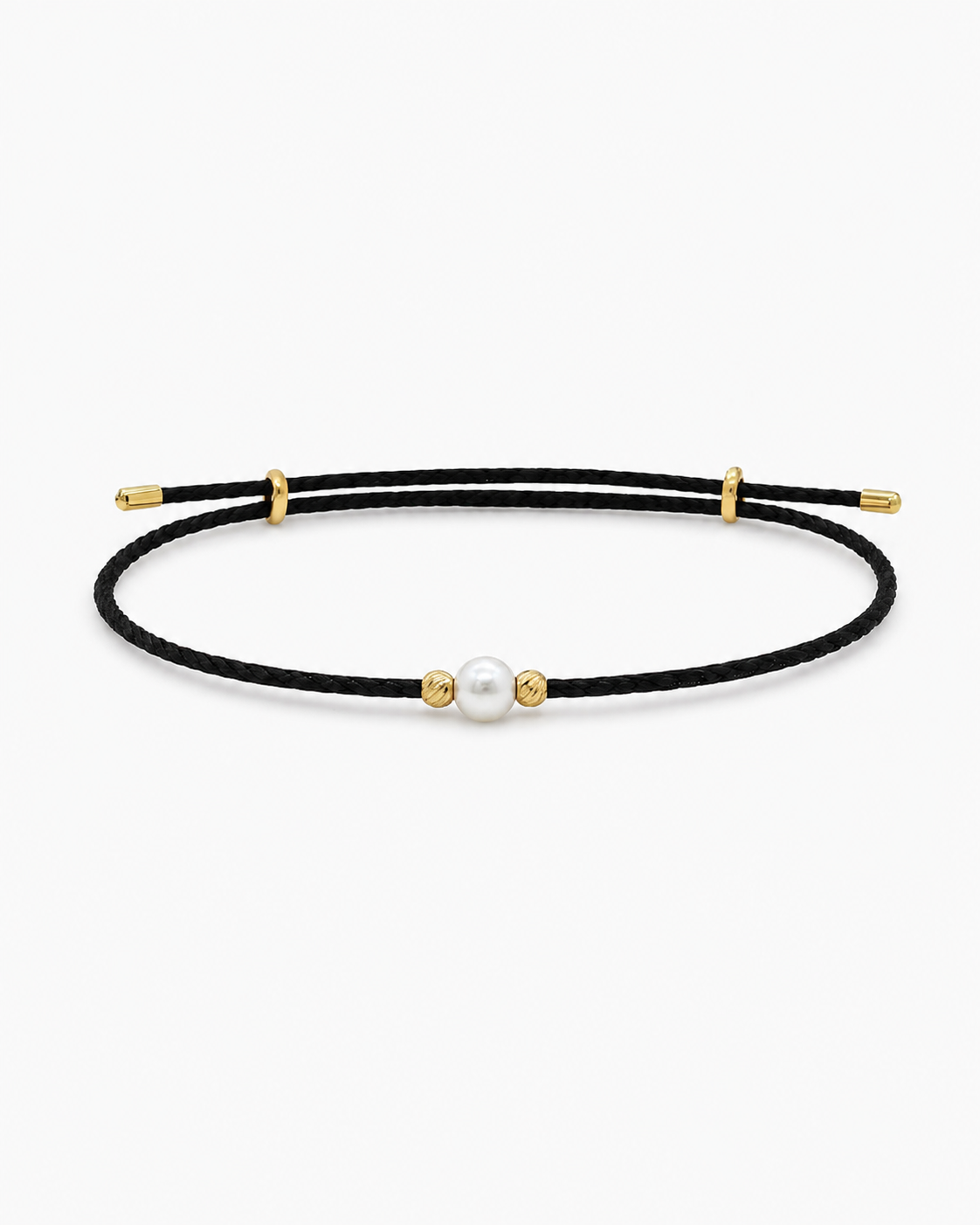 Black cord bracelet with gold accents and a pearl on a white background