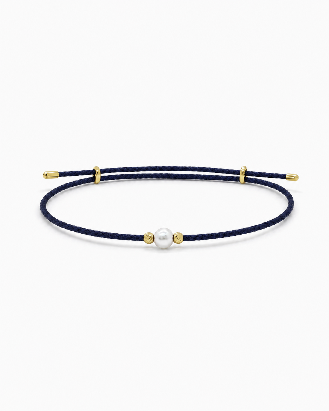 Navy blue cord bracelet with gold accents and a pearl bead on a white background #Color_