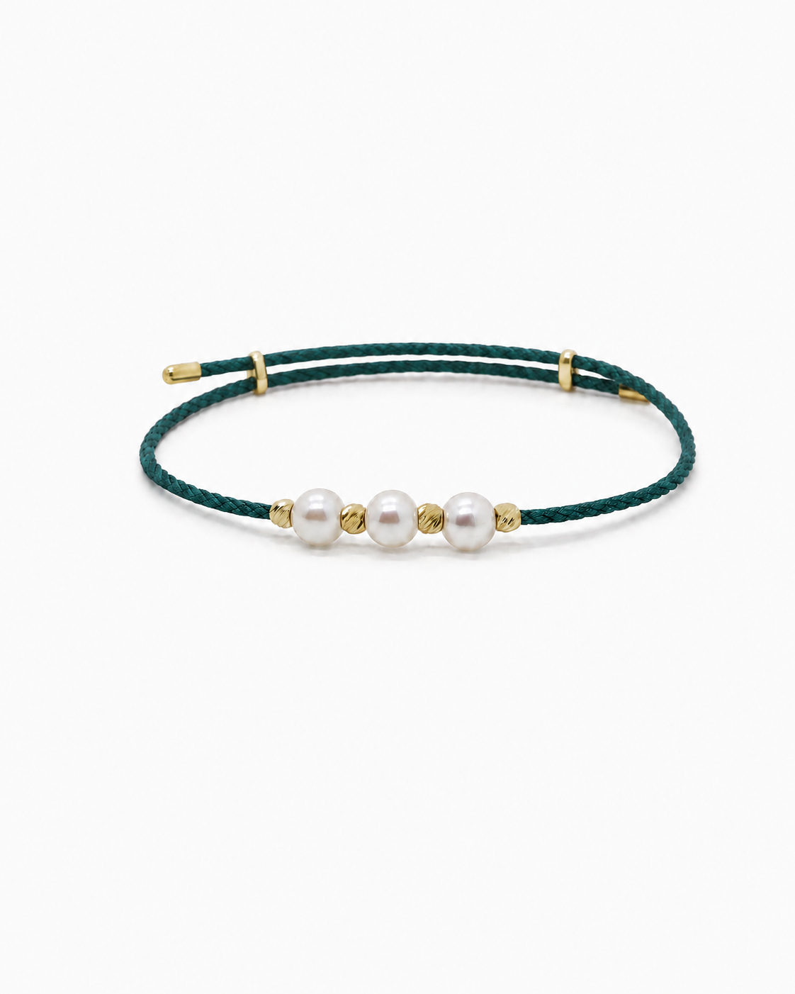Green bracelet with gold accents and three white pearls on a white background #Color_Emerald