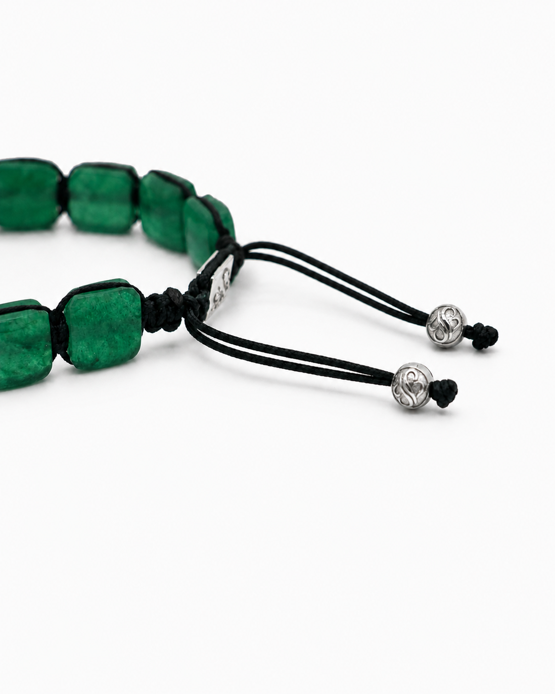 Green beaded bracelet with black cord on a white background