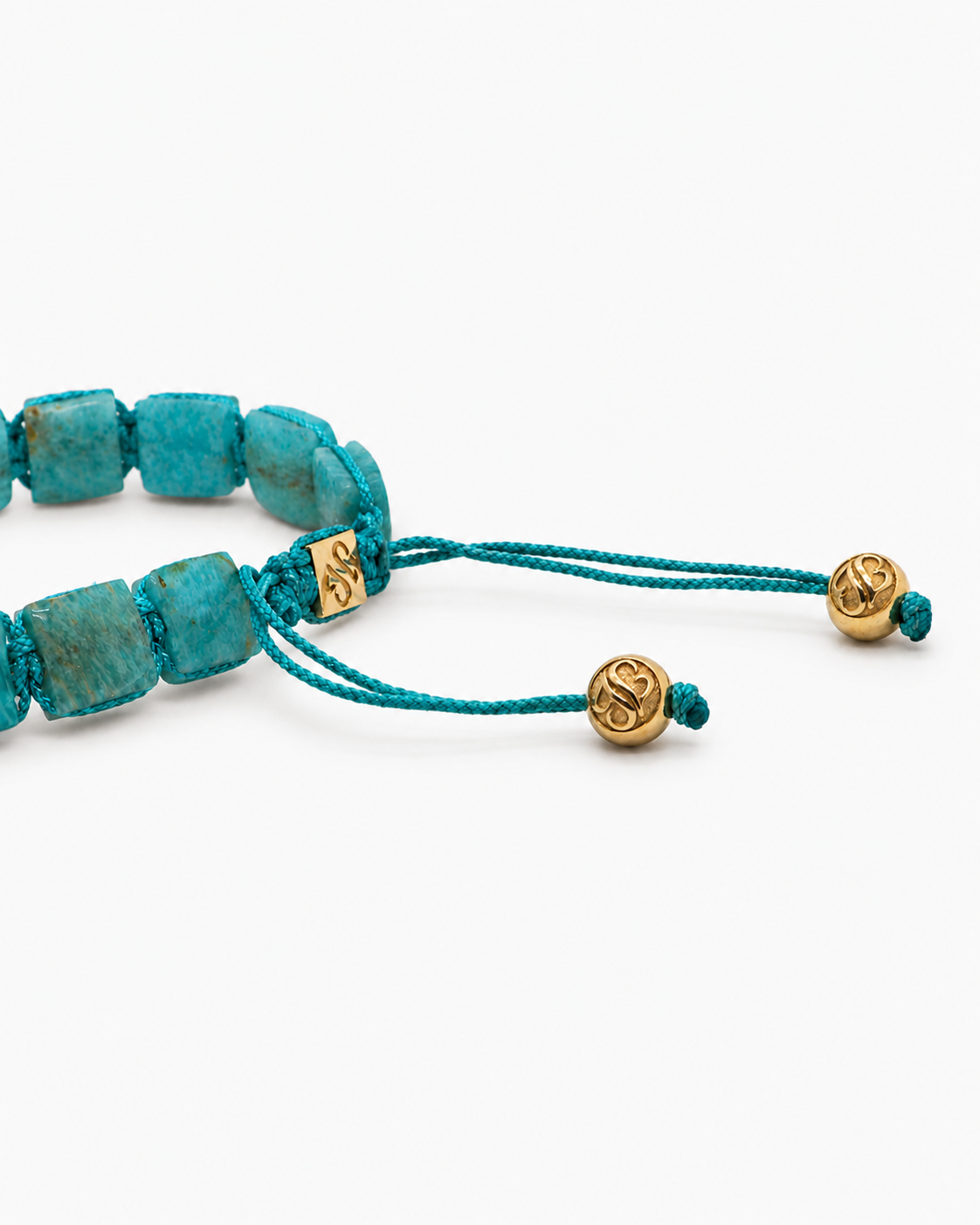 Turquoise beaded bracelet with gold accents on a white background
