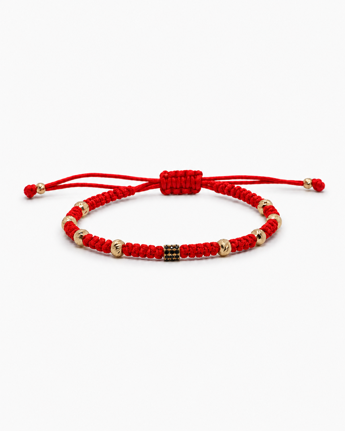 Red macrame bracelet with gold and black beads on a white background