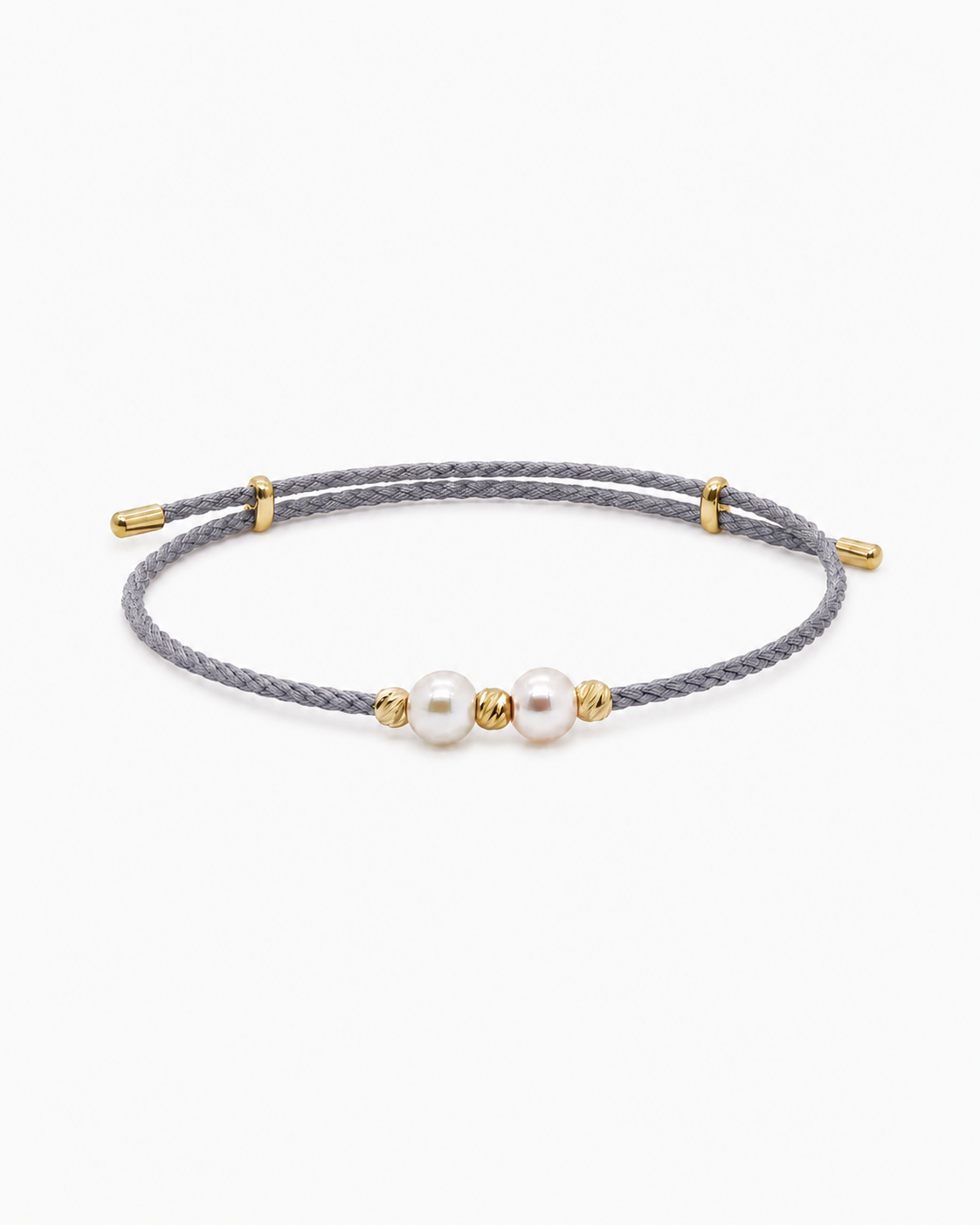 Gray braided bracelet with gold accents and two pearls on a white background #Color_