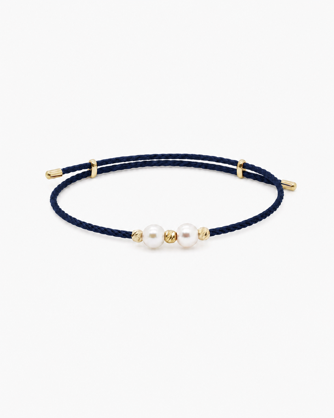 Navy blue bracelet with gold accents and pearls on a white background #Color_