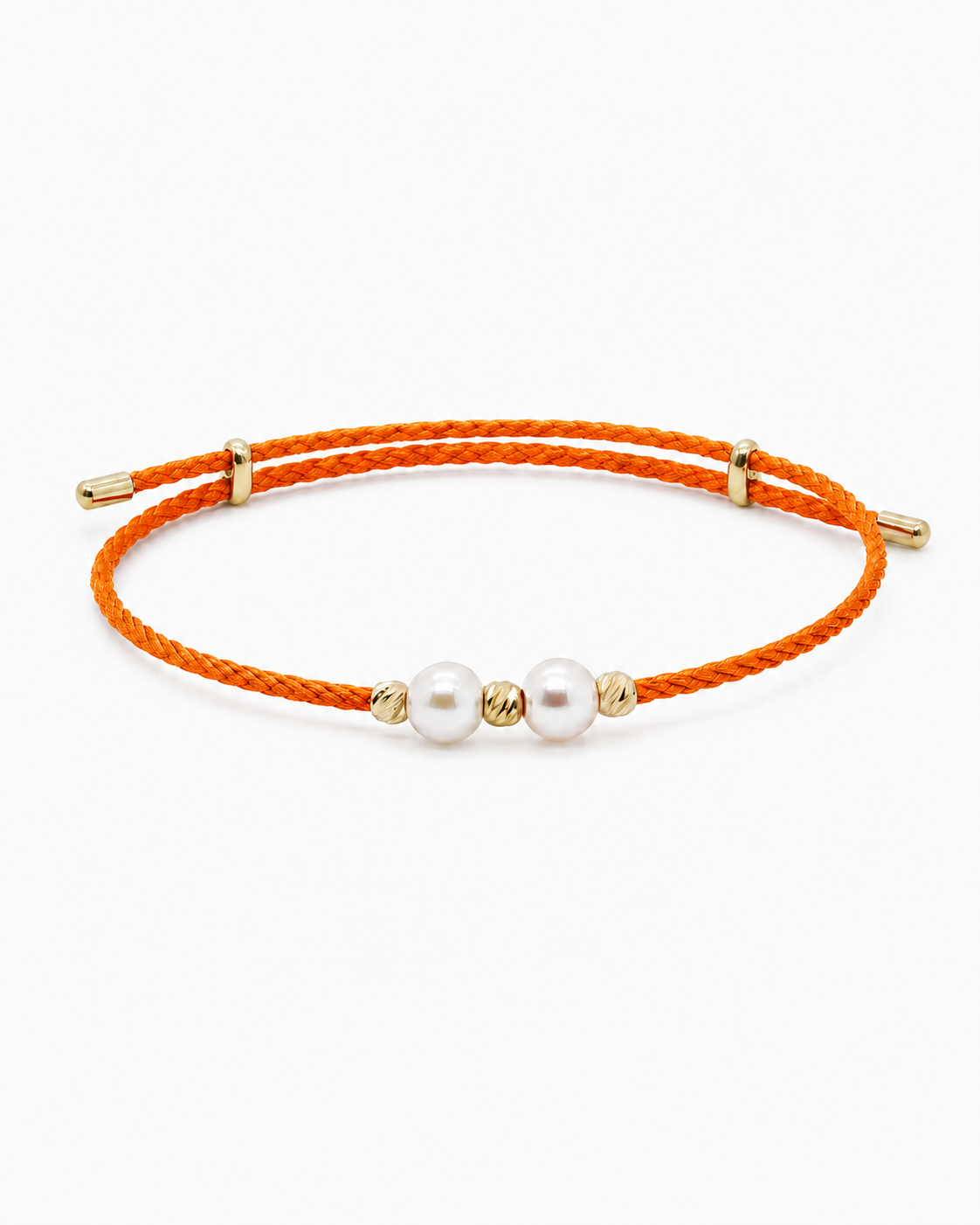 Orange bracelet with pearls and gold accents on a white background #Color_