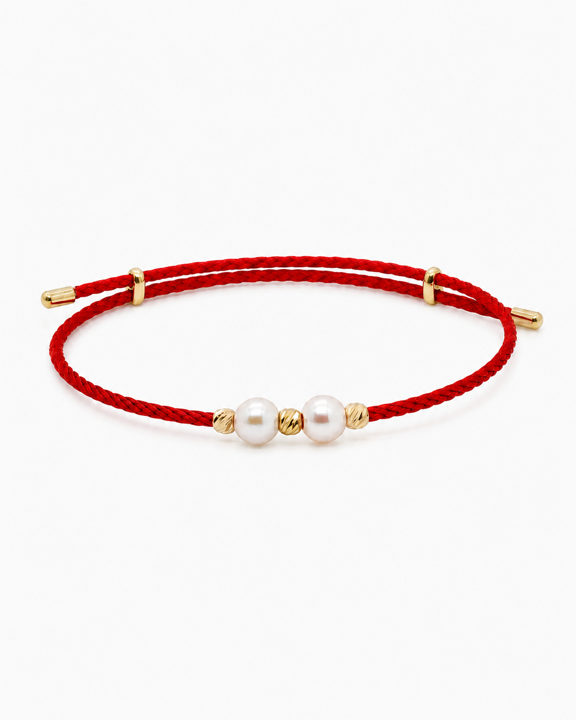 Red bracelet with gold accents and pearls on a white background