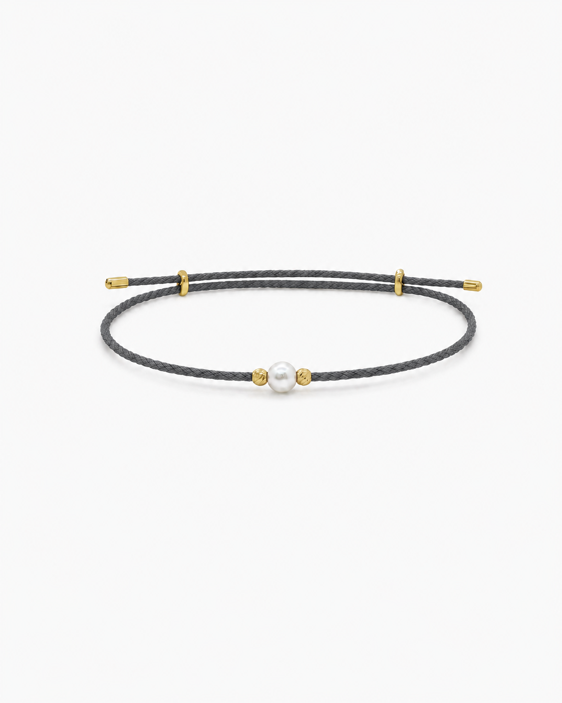 Black cord bracelet with a pearl and gold accents on a white background #Color_