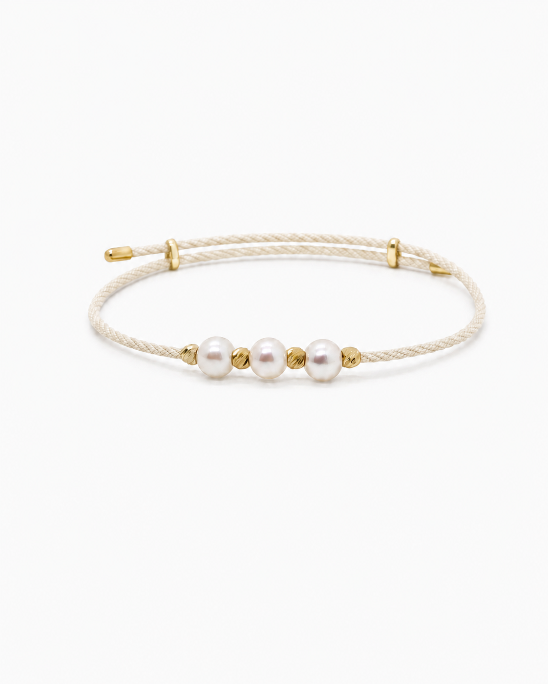 Bracelet with three pearls on a white background #Color_Nude